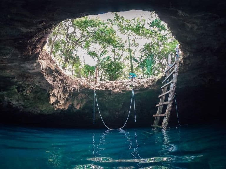 Rope swing and jumping into the water at Cenote Calavera